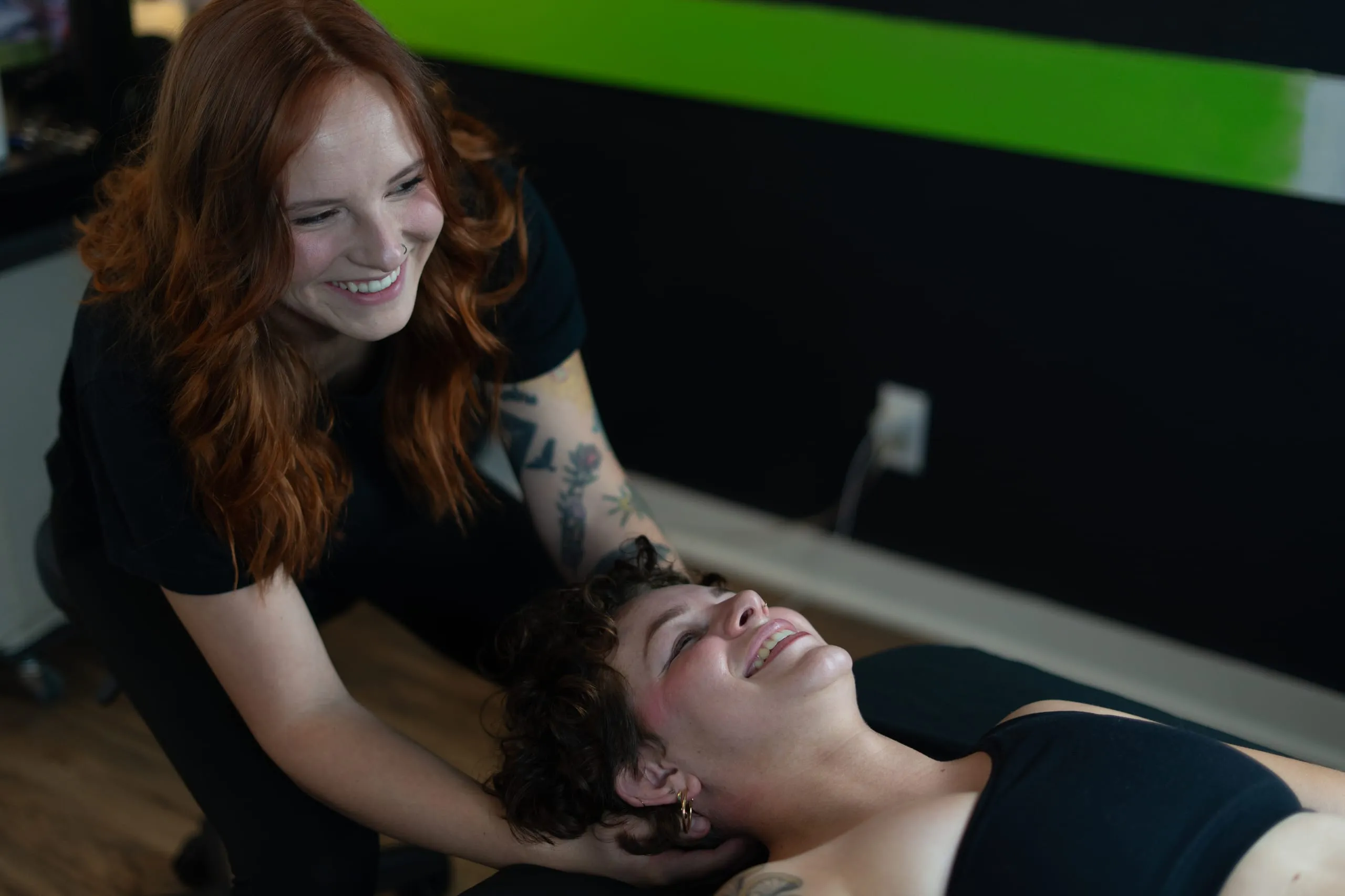 Isabelle and a client smiling during a bodywork session
