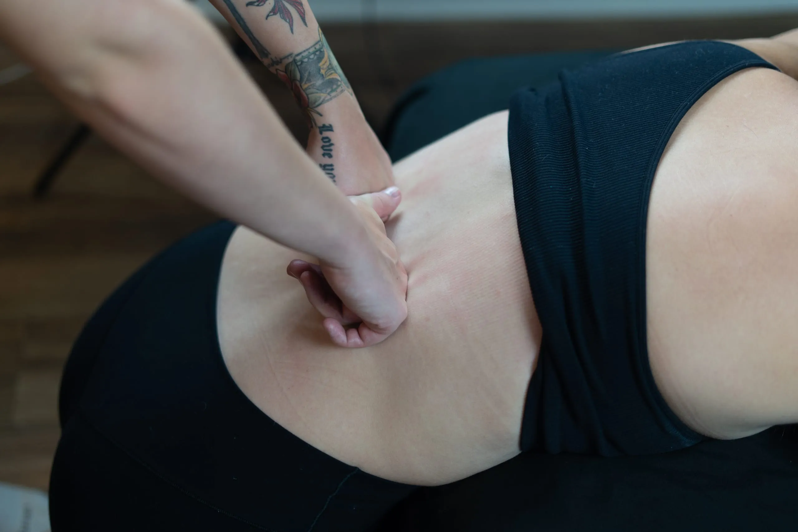 Isabelle's hands working a client's lower back